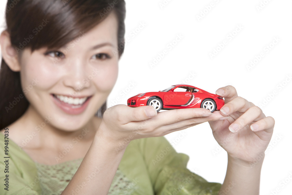 Portrait of Young Woman with Toy Car