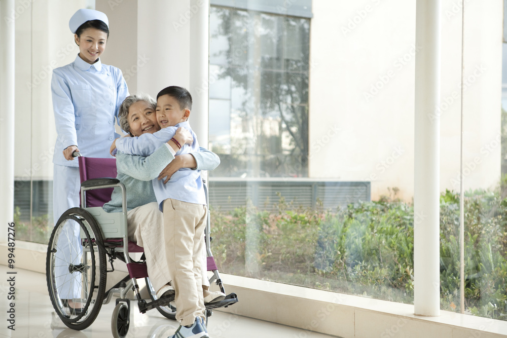 Grandson Embraces Grandmother in Wheelchair