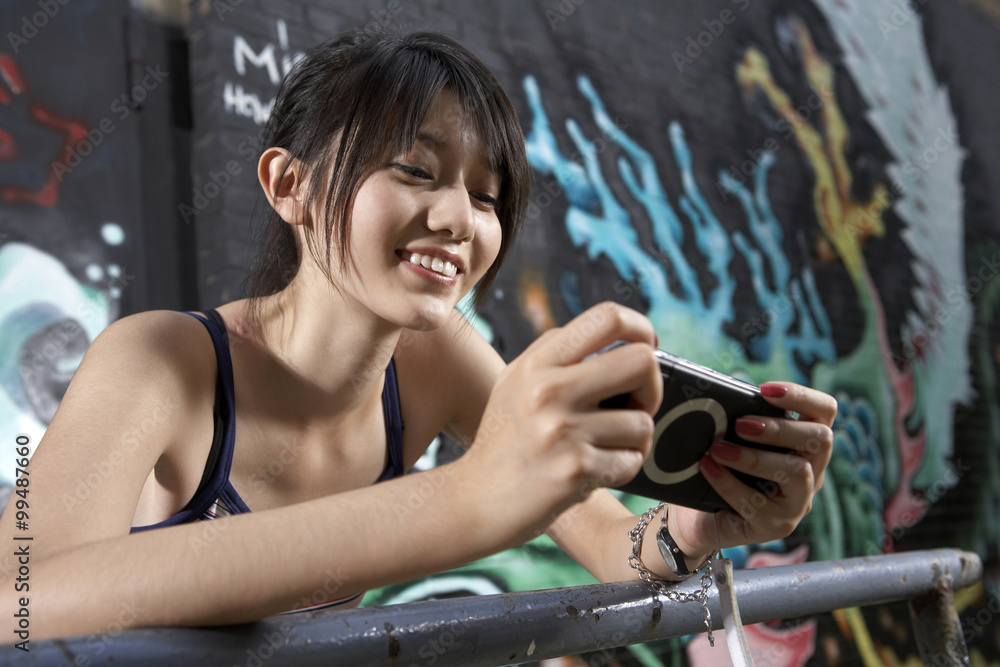 Teenage Girl With Personal Game Console