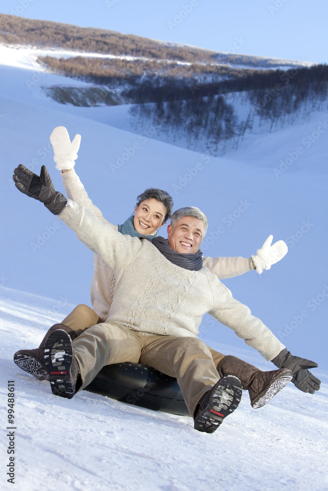 Senior couple having fun in snow