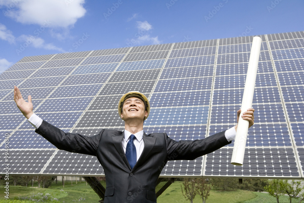 Portrait of an engineer in front of solar panels