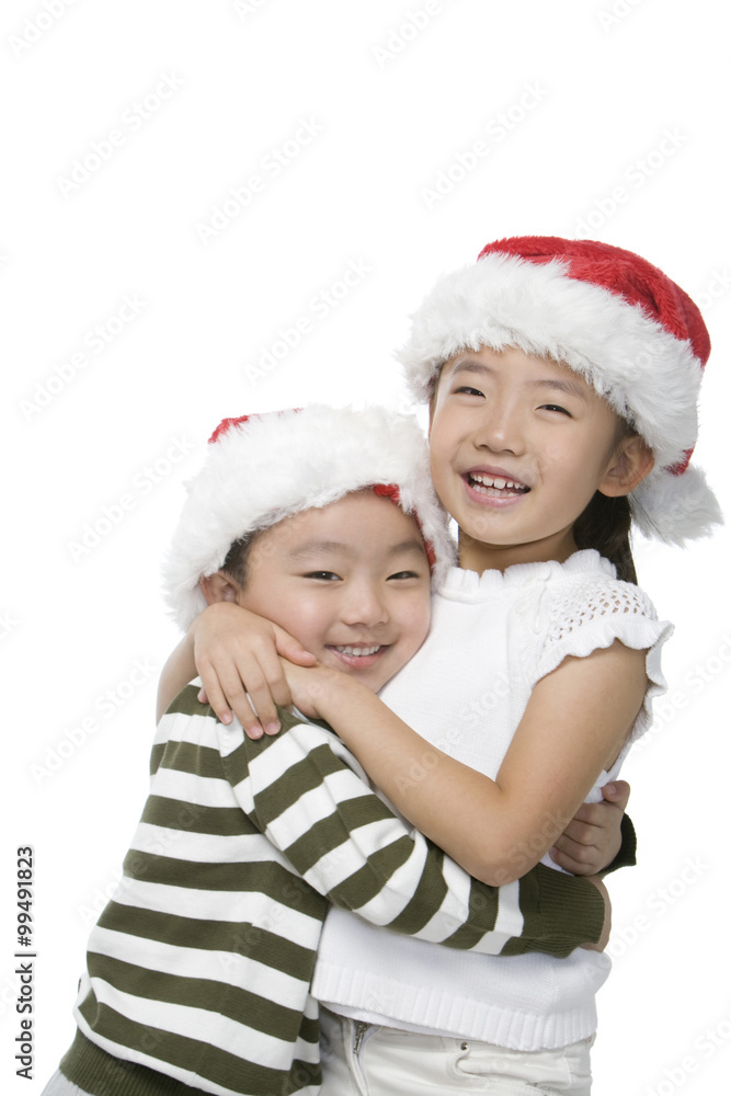 Boy and girl with Santa hats