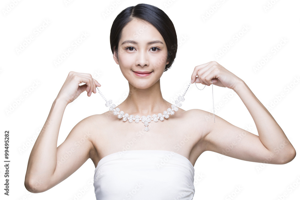 Beautiful young woman with diamond necklace