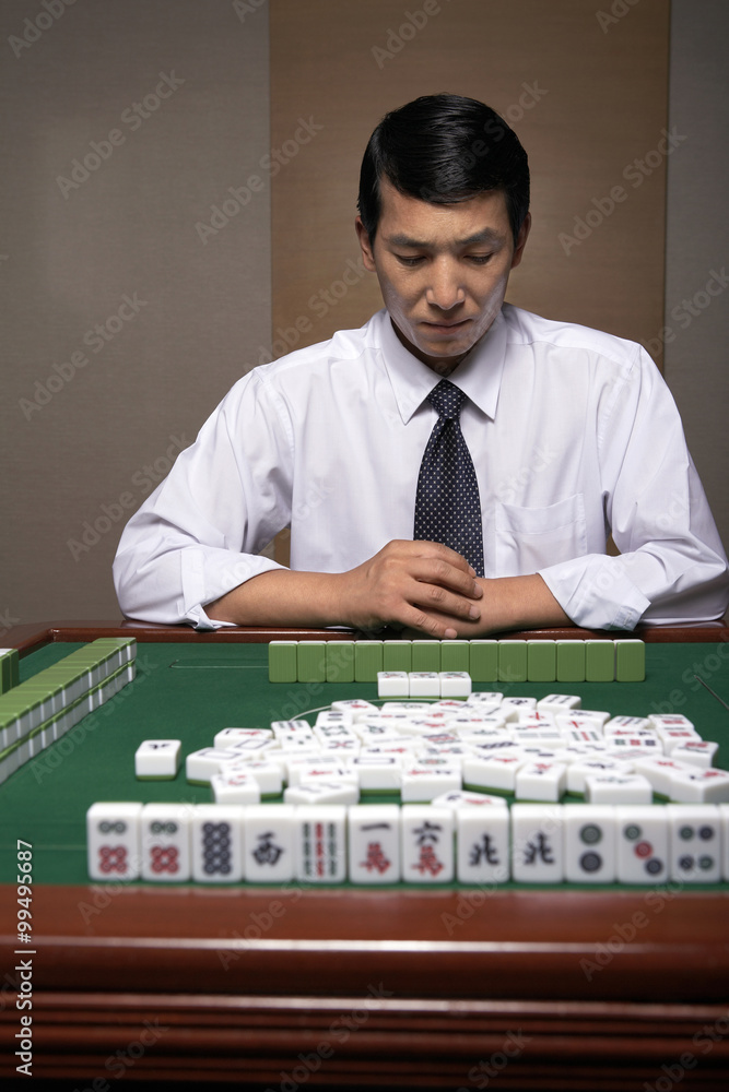 A businessman plays Mahjong