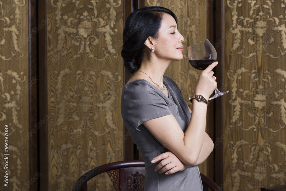 Elegant woman with red wine