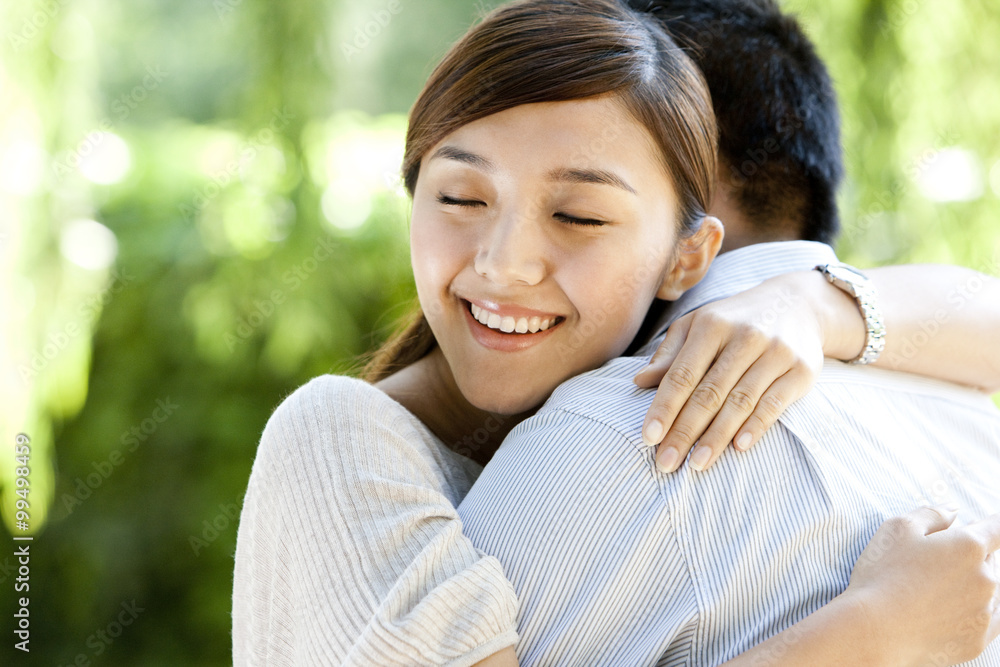 Young Chinese couple embraching in a park