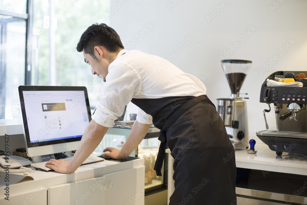 Coffee shop owner using computer