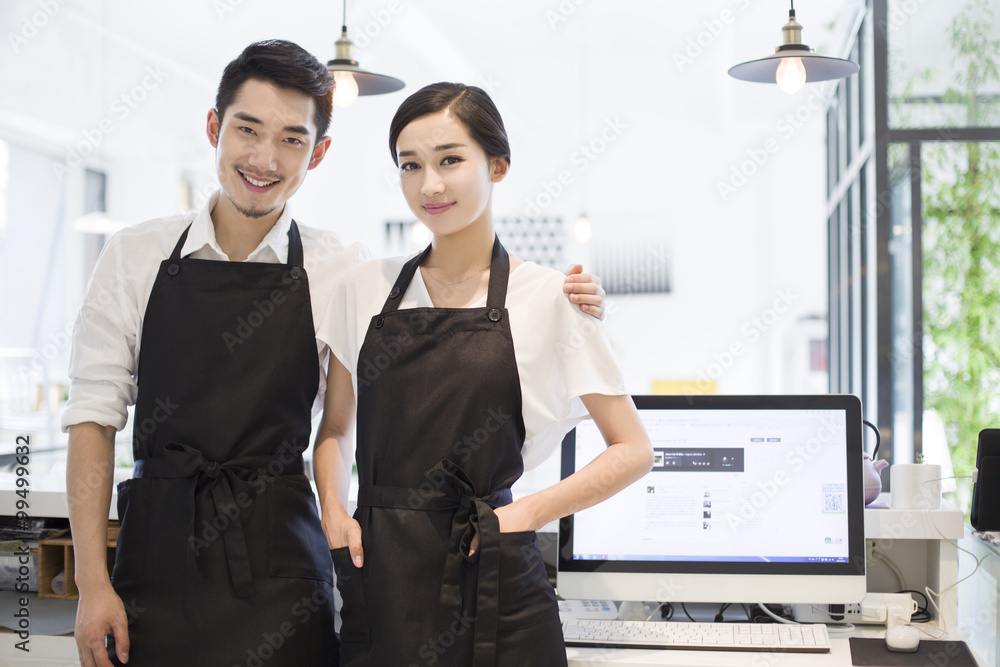 Young couple working in coffee shop