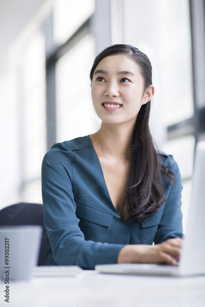 Young businesswoman working in office