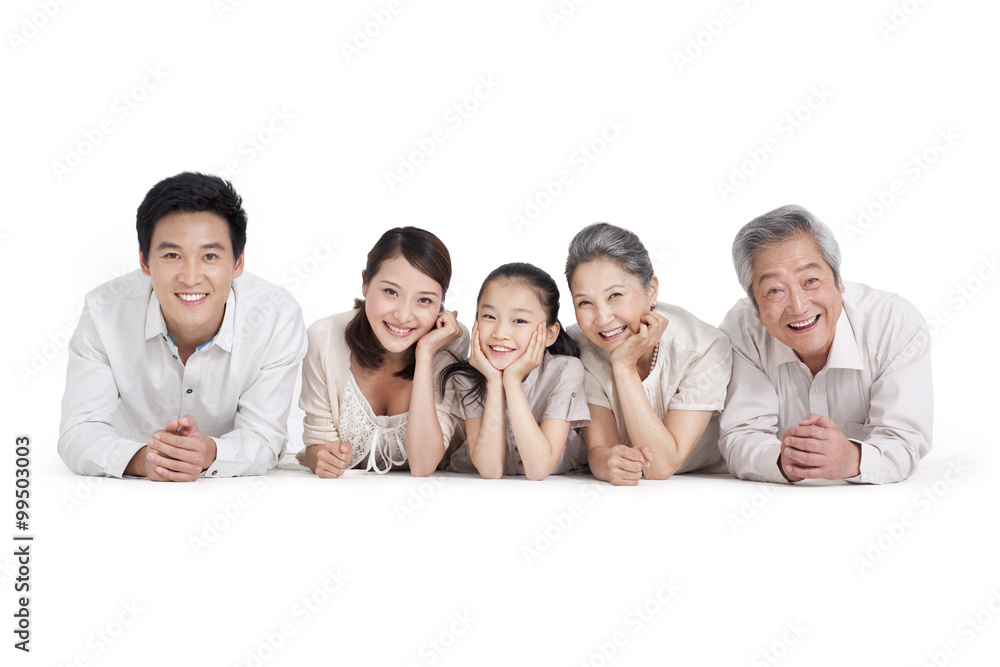 Happy family lying on front, studio shot