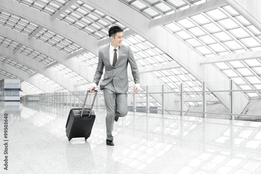 Young businessman in a hurry at the airport