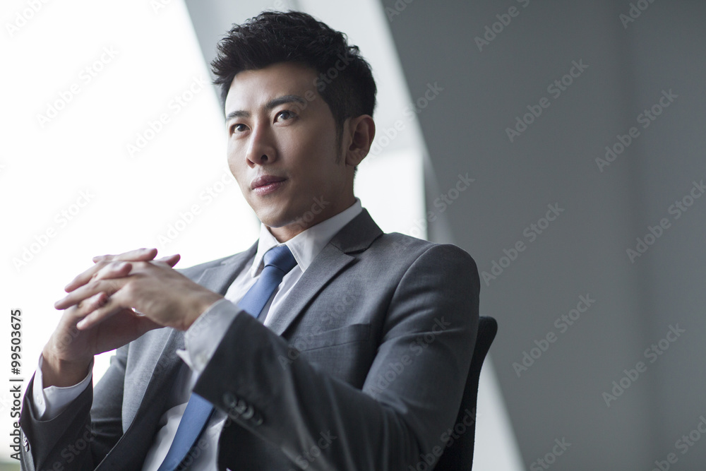 Young businessman thinking