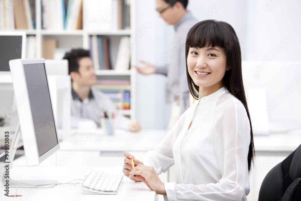 Happy young business colleagues at work in the office