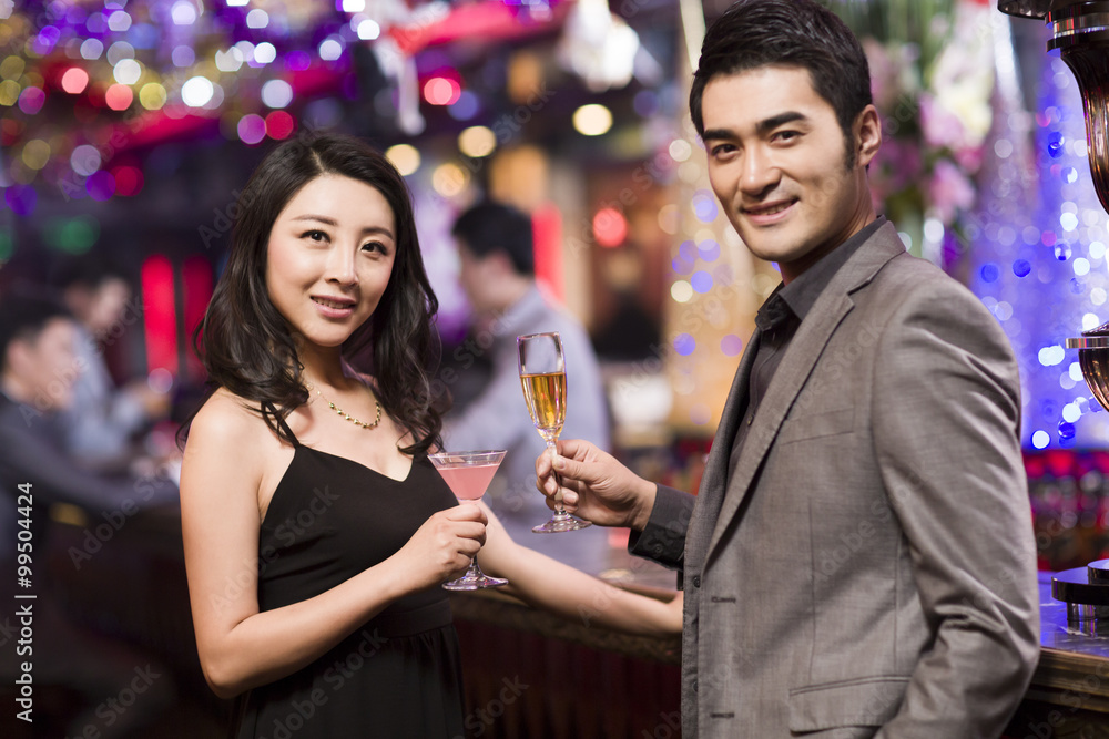 Young woman talking with young man in bar