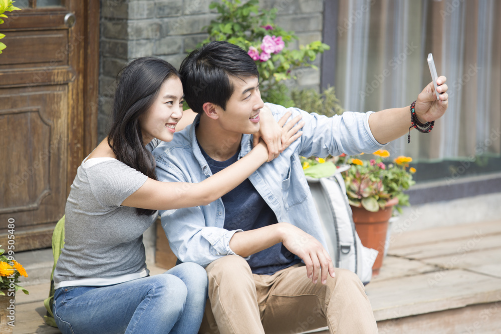 Young couple taking self portrait with smart phone