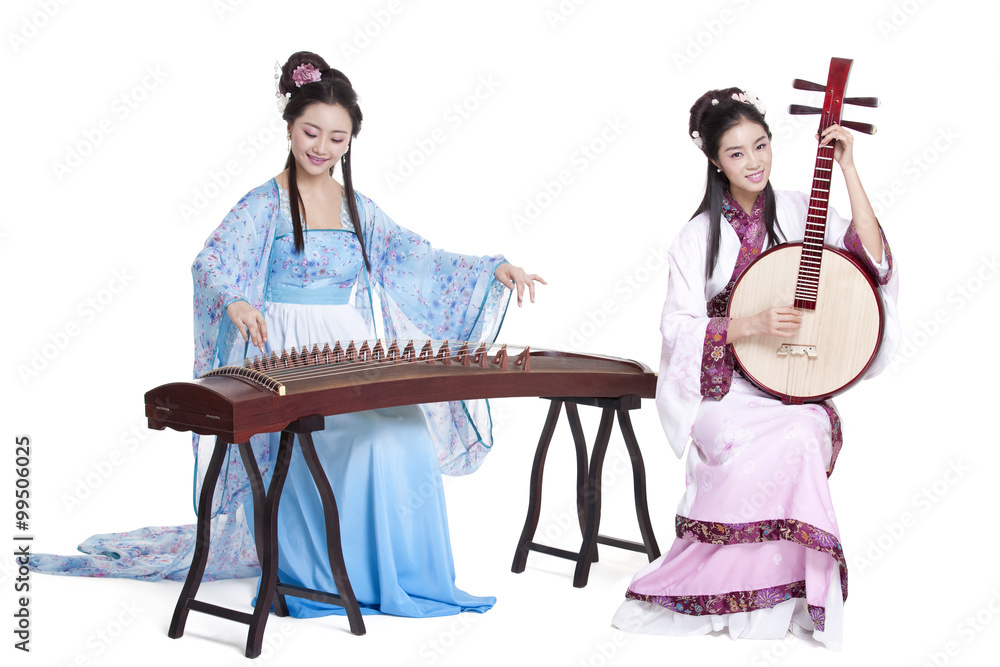 Young women in Chinese traditional costume plucking classical musical instruments