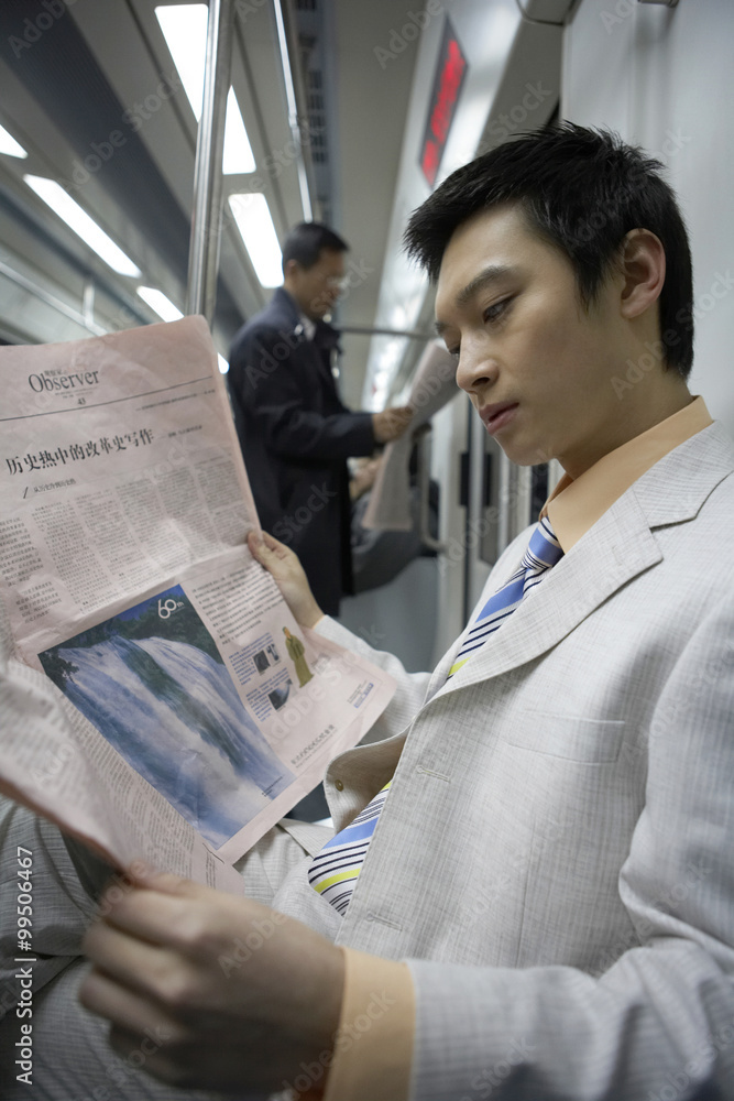 Man Reading Newspaper On Train