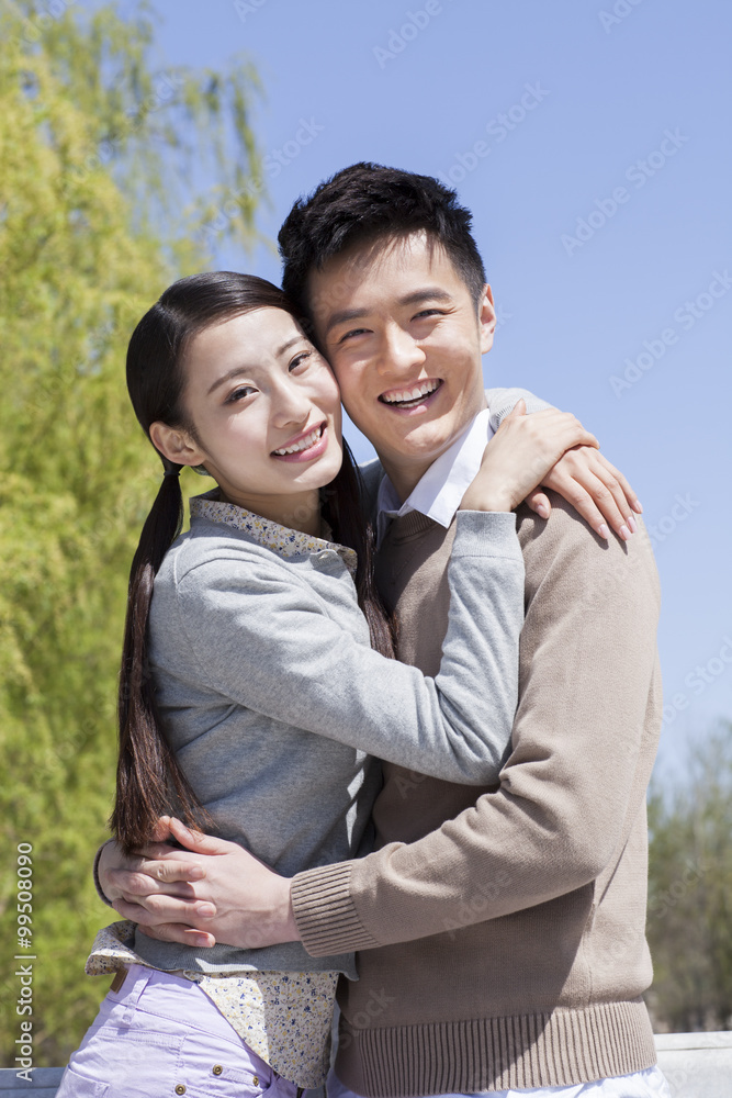 Sweet young couple embracing outdoors