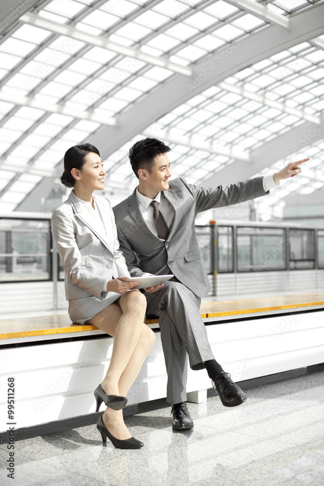 Business colleagues looking at view at subway station