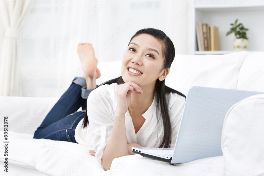 Young woman using laptop at home