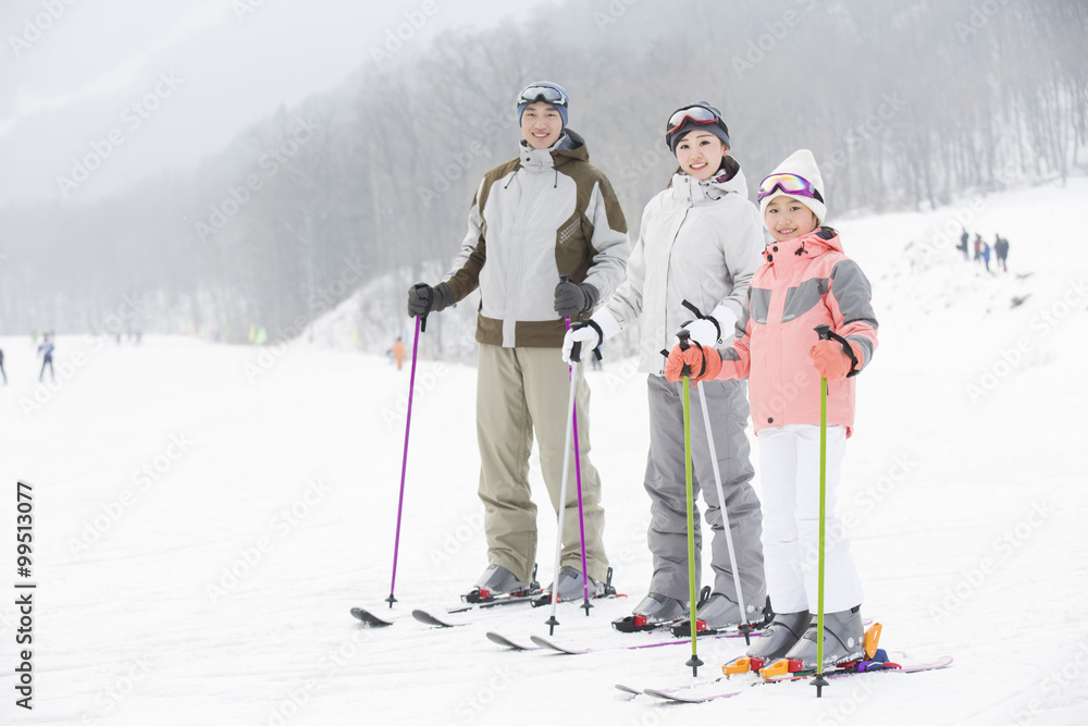 Young family skiing in ski resort