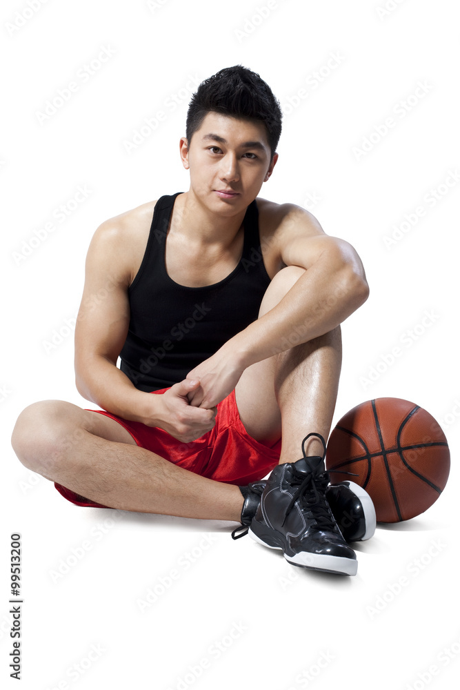 Man sitting on the floor with basketball