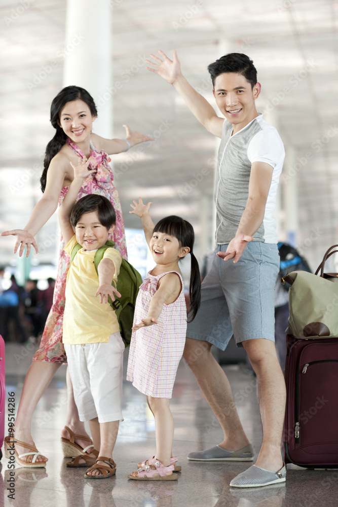 Happy family with luggage at the airport