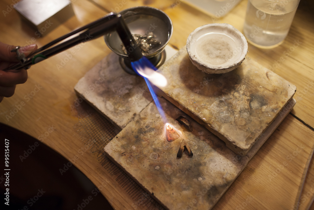 Welding torch melting the silver ornaments