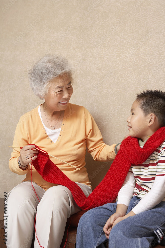 Grandmother Knitting Scarf With Grandson