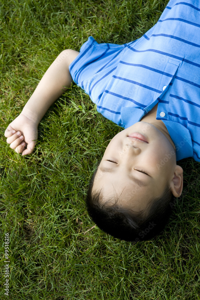 Boy lying on the grass