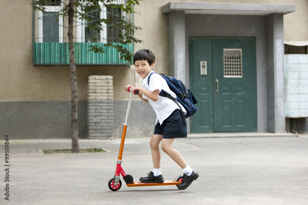 Boy on a push scooter