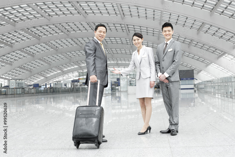 Young business partners with name tags greeting guest at the airport