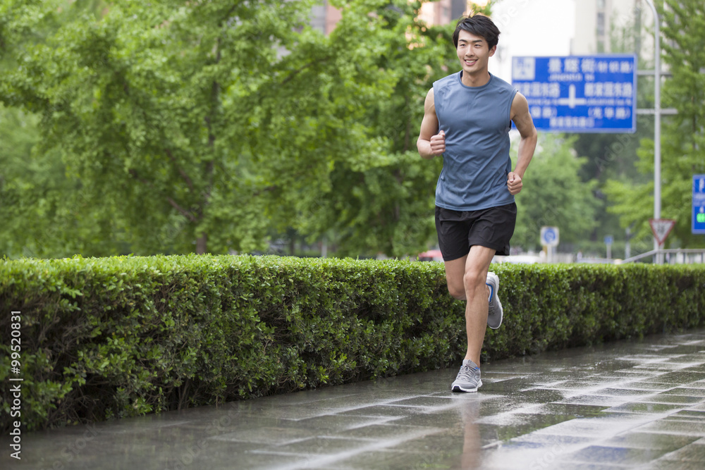 Young man running outside