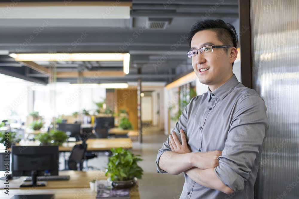 Young man standing in office