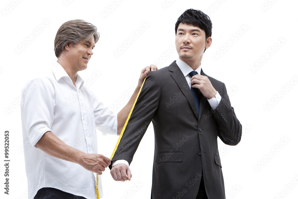 Fashion designer taking a measurement of  businessman