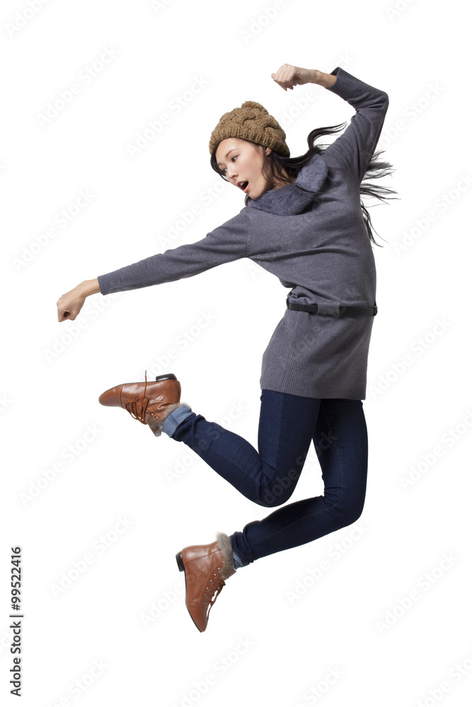 Young woman jumping in mid-air