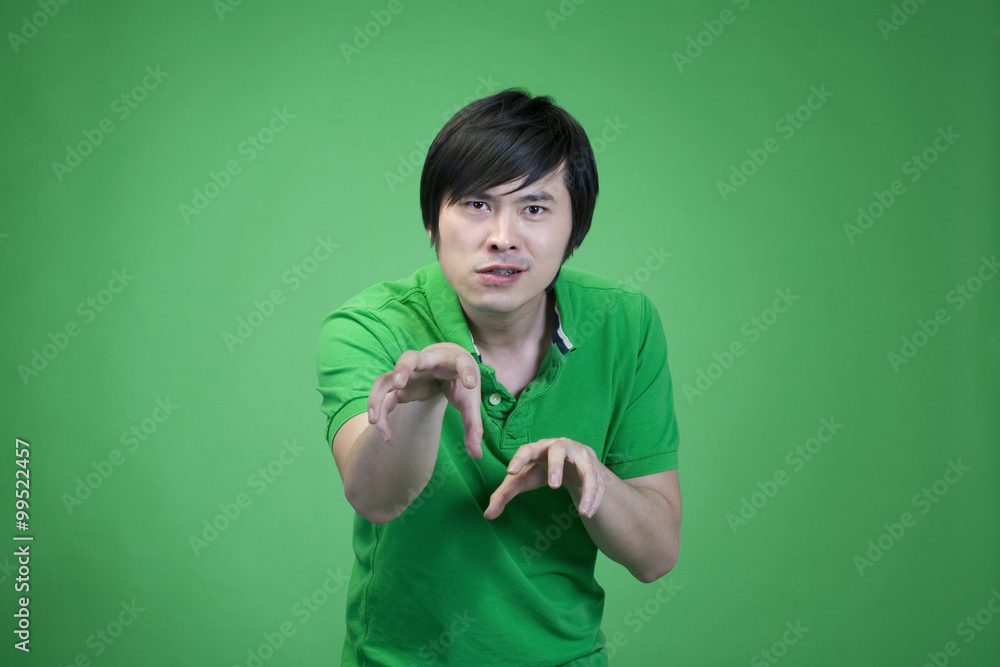 Man in green on green background practicing kung fu