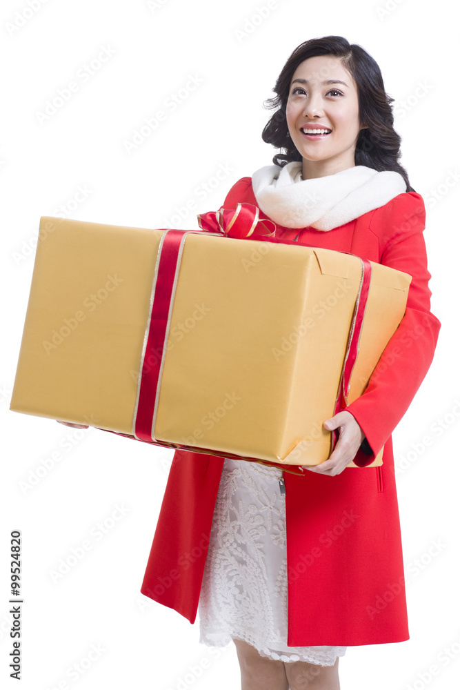 Happy young woman holding a large gift