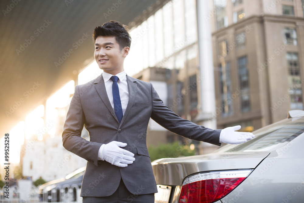 Chauffeur greeting next to the car