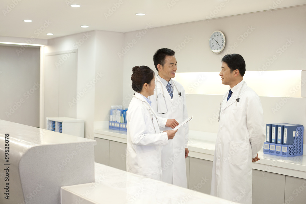 A group of doctors talking behind a deask