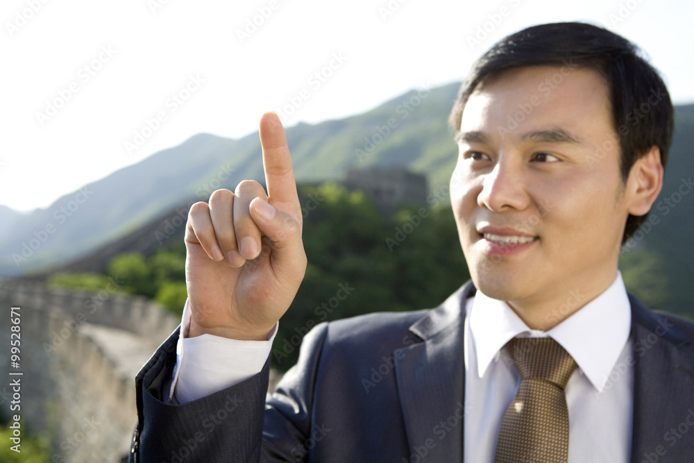 Businessman pointing while on the Great Wall