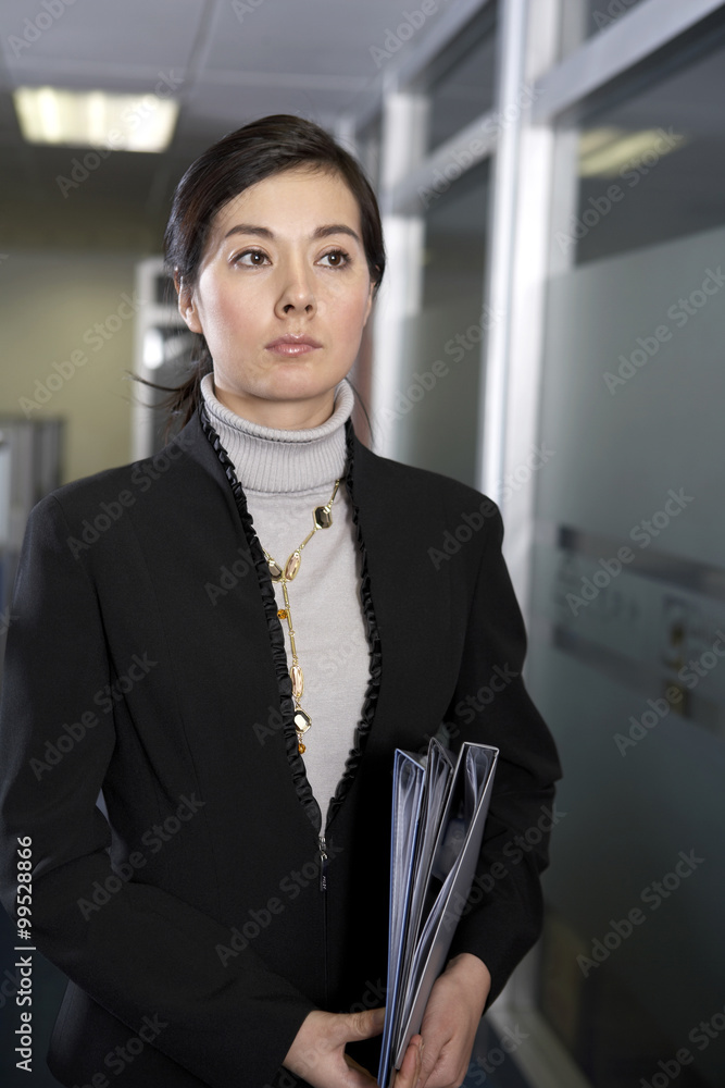 Woman Holding Clipboards Looking Serious