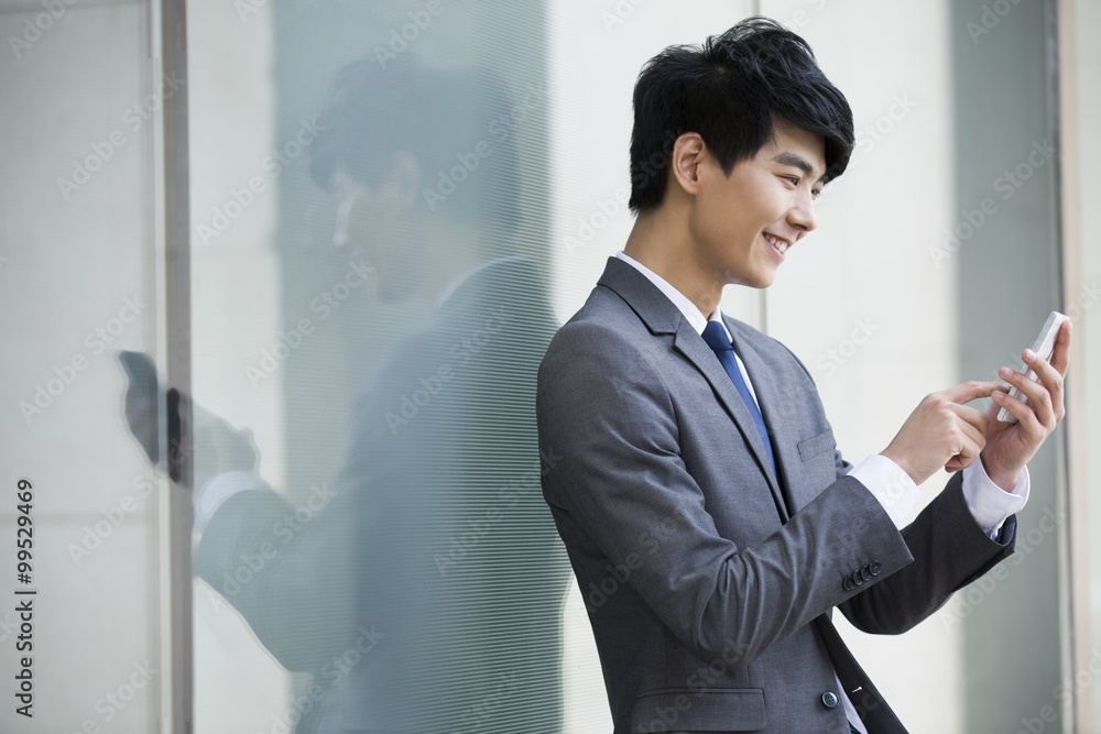 Young businessman using mobile phone