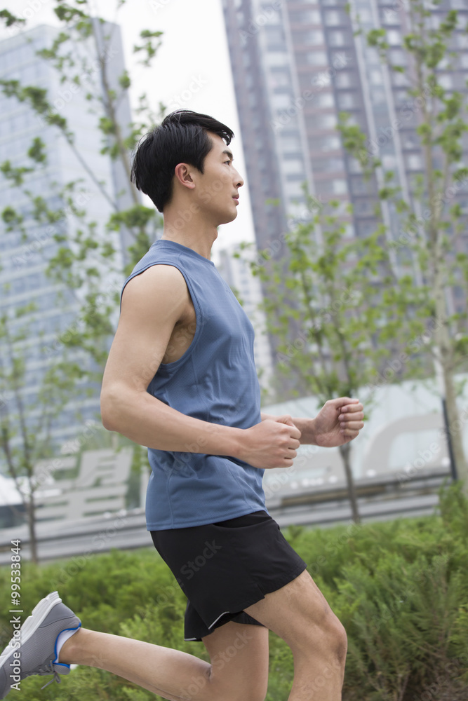 Young man running outside