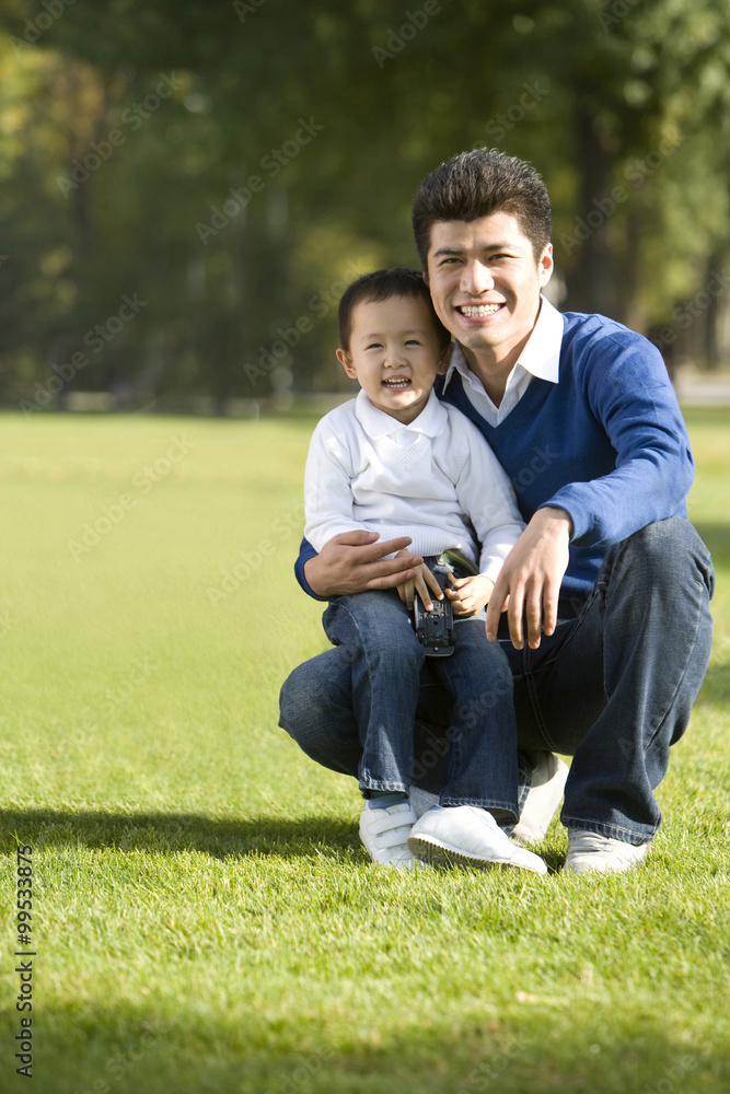 Portrait of father and son in the park