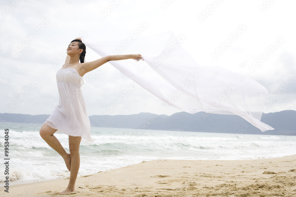 A woman dancing at the beach