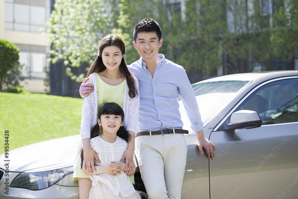 Happy young family and car