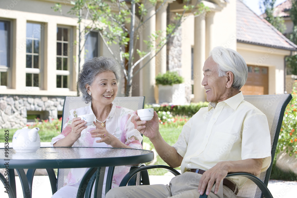 Senior couple chatting and having tea