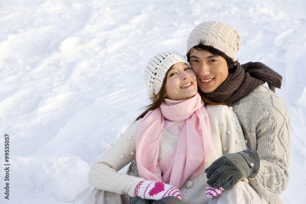 年轻情侣在雪地里拥抱