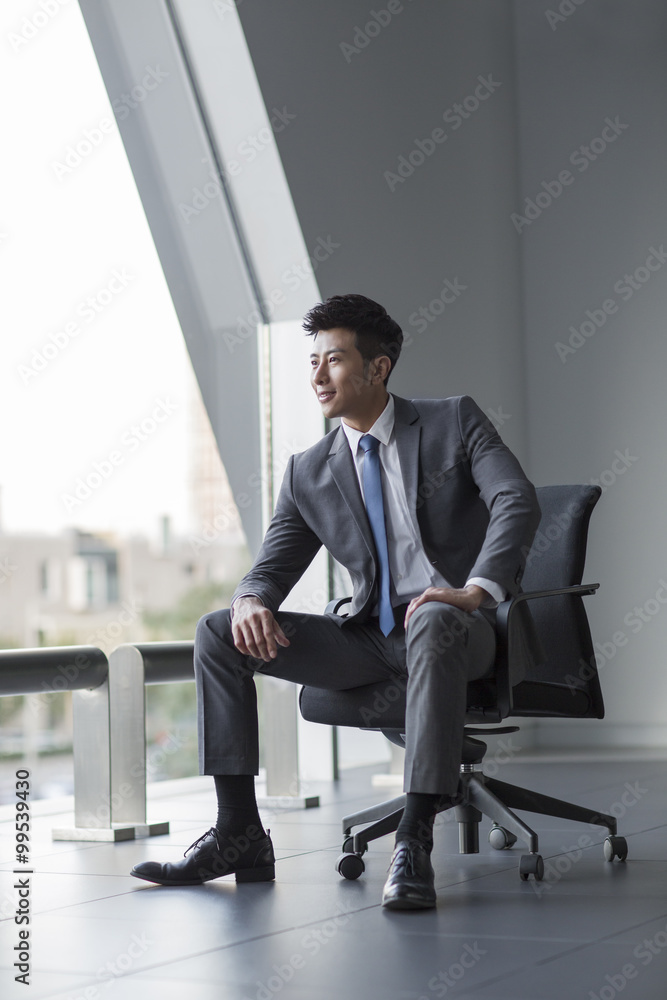 Young businessman looking at view